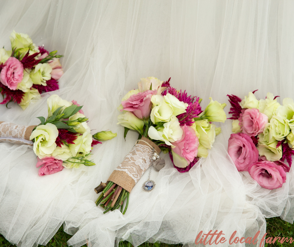pink and white bridal bouquet on brides dress